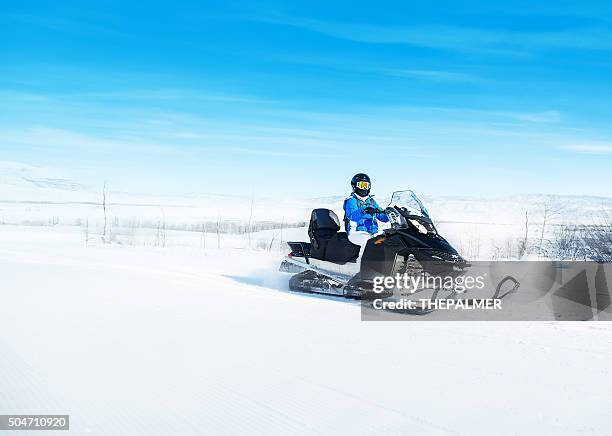 woman driving snowmobile - snowmobile stock pictures, royalty-free photos & images