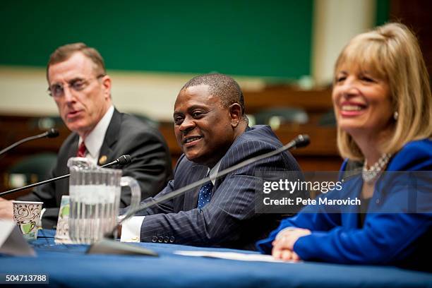 Rep. Tim Murphy and forensic pathologist and neuropathologist Dr. Bennet Omalu participate in a briefing sponsored by Rep. Jackie Speier , right, on...