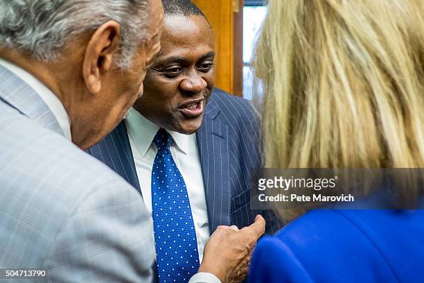 Forensic pathologist and neuropathologist Dr. Bennet Omalu is greeted by members of Congress before participating in a briefing sponsored by Rep....