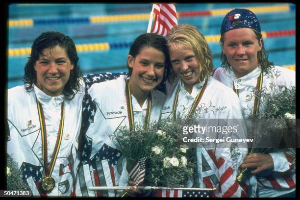 Amer. 4x100-m relay swimmers Jenny Thompson, Crissy Ahmann-Leighton, Anita Nall & Lea Loveless w. Gold medals won in event at 1992 Summer Olympics.