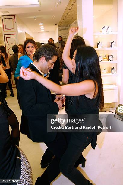 Artist JonOne and his wife Mai Lucas Perello dance during the Guerlain collaboration with Graffiti Artist JonOne, Color Flows Exhibition Launch's...