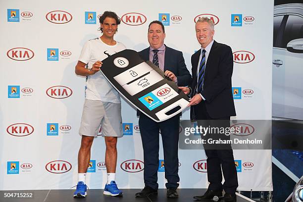 Rafael Nadal of Spain, Kia COO Damien Meredith and Australian Open Tournament Director Craig Tiley pose during a Kia Key handover ceremony at Garden...