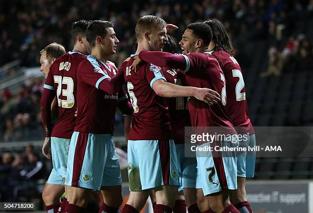 Andre Gray of Burnley celebrates with his team mates after scoring to make it 0-3 during the Sky Bet Championship match between MK Dons and Burnley...