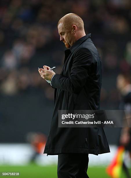 Sean Dyche manager of Burnley takes notes during the Sky Bet Championship match between MK Dons and Burnley at Stadium mk on January 12, 2016 in...