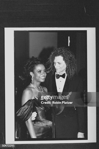 Actress Tonya Pinkins wearing low-cut strapless evening gown as she poses w. Her husband Ron Breyer at Tony Awards party.