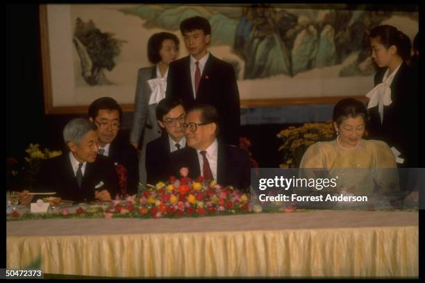 Communist Party chief Jiang Zemin hosting Japanese Emperor & Empress, Akihito & Michiko, at state banquet, w. Pair of hovering interpreters.