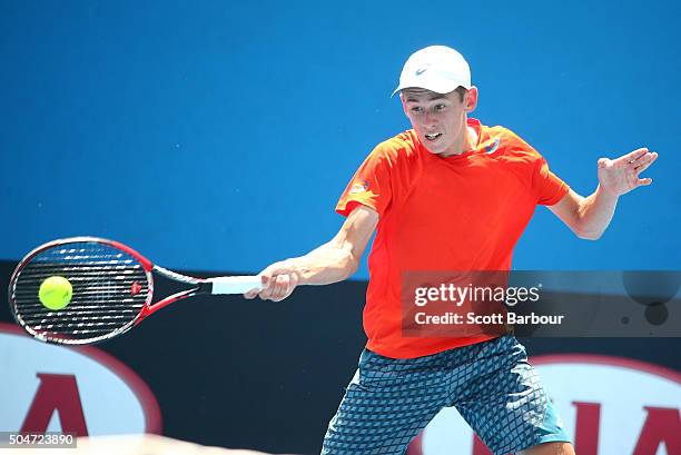 Alex De Minaur of Australia plays a forehand in his match against Kimmer Coppejans of Belgium during round one of 2016 Australian Open Qualifying at...