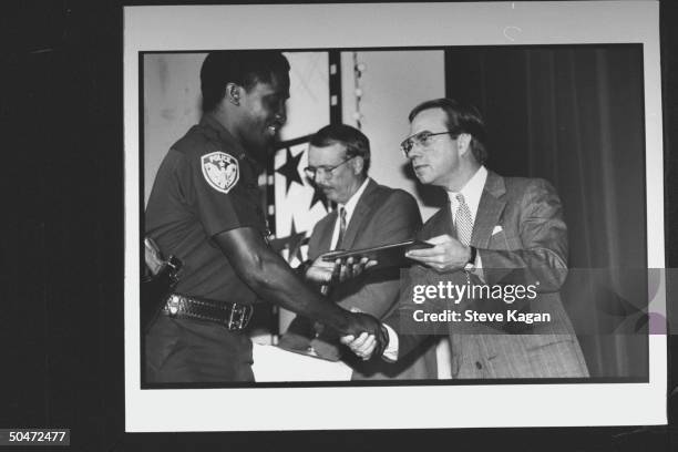 State Treasurer/Dem. Nominee for US Congress George Wallace Jr. Shaking hands black SW AL police academy grad. While handing him his graduation...