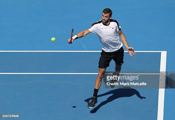 Grigor Dimitrov of Bulgaria plays a backhand in his match against Pablo Cuevas of Uruguay during day four of the Sydney International at Sydney...