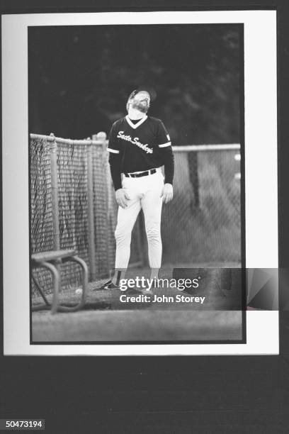 Actor/semi-pro baseball pitcher Timothy Busfield in his Sacramento Smokies uniform, standing in bullpen, stretching his neck as he prepares to warm...