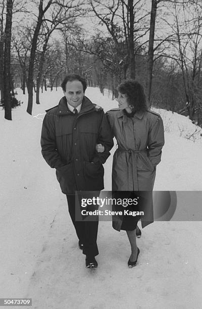 Sen. Paul Wellstone w. His wife Sheila, walking in snowy park.