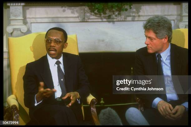 Pres. Bill Clinton mtg. W. Jean-Bertrand Aristide, deposed democratically-elected pres. Of Haiti, in WH Oval Office, re restoring him to office.