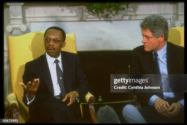 Pres. Bill Clinton mtg. W. Jean-Bertrand Aristide, deposed democratically-elected pres. Of Haiti, in WH Oval Office, re restoring him to office.