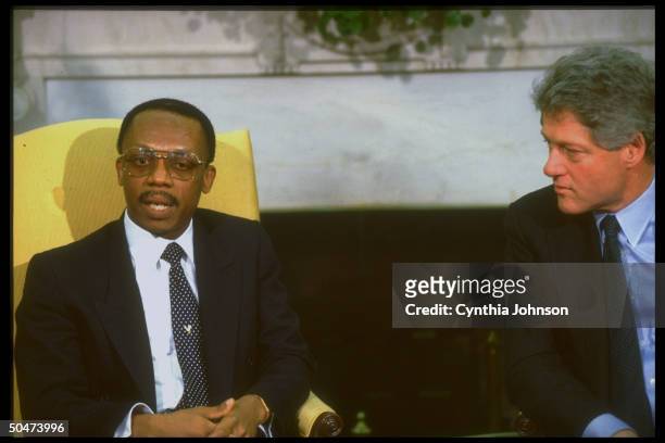Pres. Bill Clinton mtg. W. Jean-Bertrand Aristide, deposed democratically-elected pres. Of Haiti, in WH Oval Office, re restoring him to office.