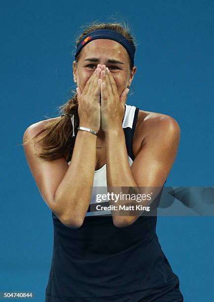 Monica Puig of Puerto Rico celebrates winning match point in her match against Samantha Stosur of Australia during day four of the Sydney...