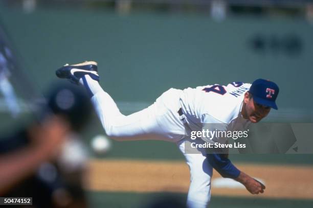 Rangers pro baseball player Nolan Ryan pitching in 7th inning of spring training game against Baltimore Orioles.