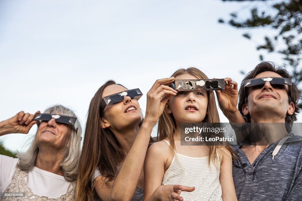 Family looking at Solar Eclipse using solar glasses