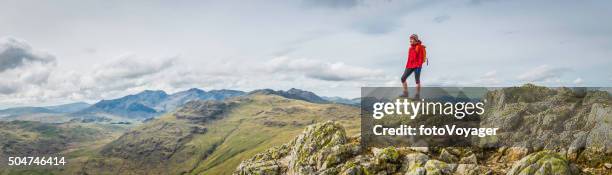 teenage female hiker on rocky mountain summit overlooking peak panorama - english lake district 個照片及圖片檔