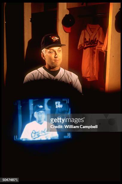 Baltimore Orioles shortstop Cal Ripken Jr. Framing his TV screen-projected image, holding interview w. FOX TV at Camden Yards.