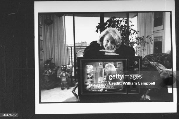 For. Correspondent & syndicated columnist Georgie Anne Geyer leaning on TV set w. Image of Markie Post in TV sitcom Hearts Afire emblazoned w....