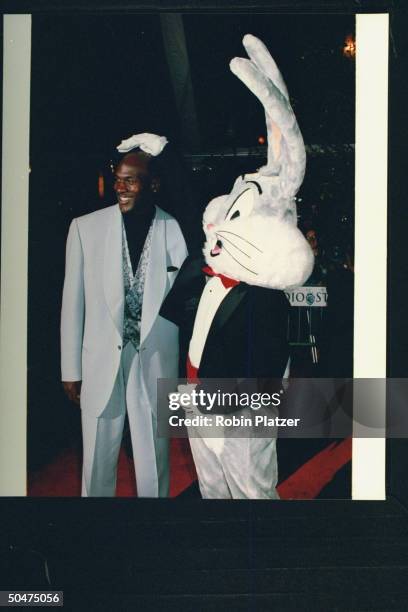 Basketball star Michael Jordan w. Life-size Bugs Bunny at opening of Warner Bros. Studio Store.