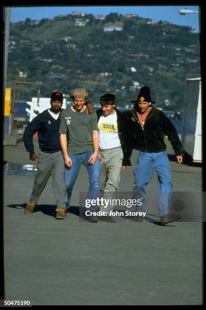 Members of rock band Hootie & the Blowfish, Jim Sonefeld, Dean Felber, Mark Bryan & Darius Rucker walking together.