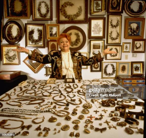 Curator Leila Cohoon surrounded by collection of Victorian objects made fr. Human hair at her Hair Museum in Independence College of Cosmetology.