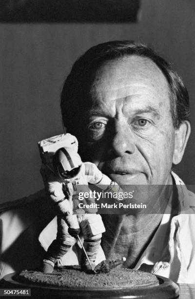 Former astronaut Alan Shepard Jr. Posing w. A small model of his 1971 Apollo 14 lunar golf shot, in the office of his business development firm.