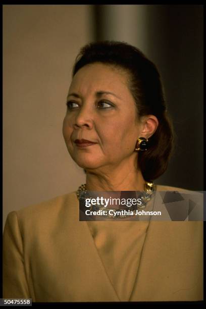 Alma Powell listening as her husband, retired Gen. Colin Powell, announces his decision not to run for pres. In 1996.