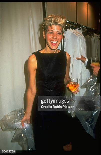 Actress Marisa Tomei holding drink at the 3rd Seventh on Sale benefit which raised $5 million for AIDS charities.