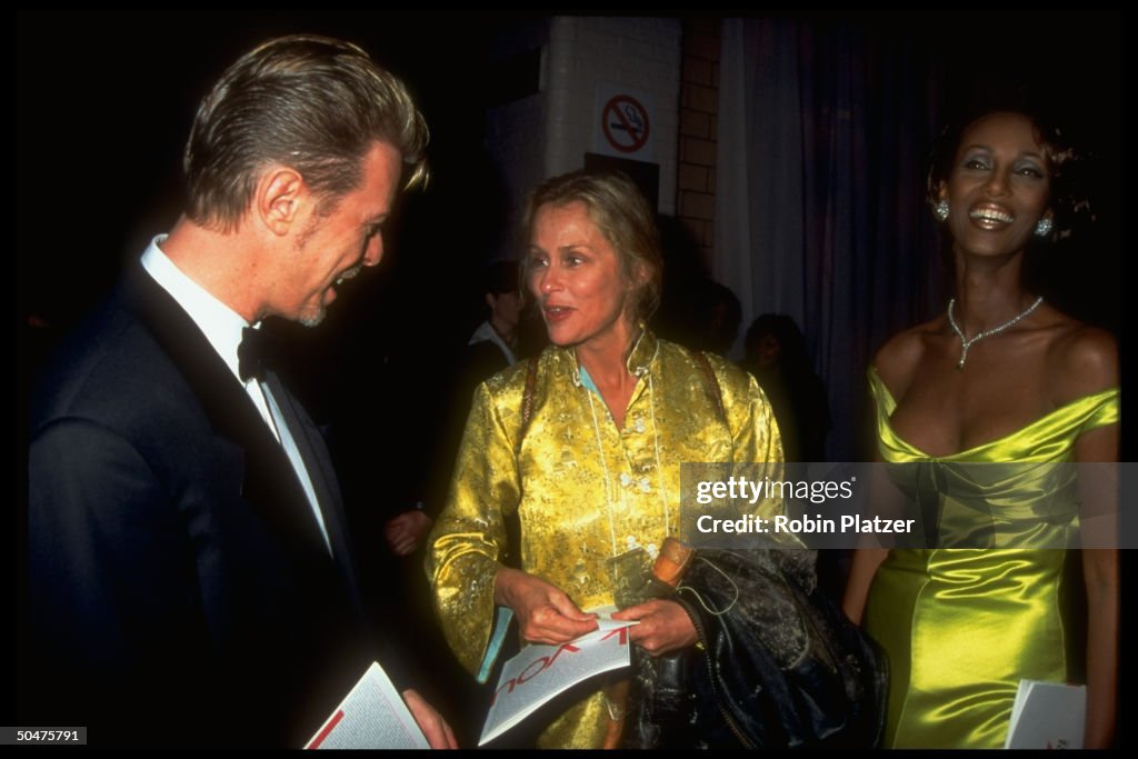 Musician David Bowie chatting w. model L
