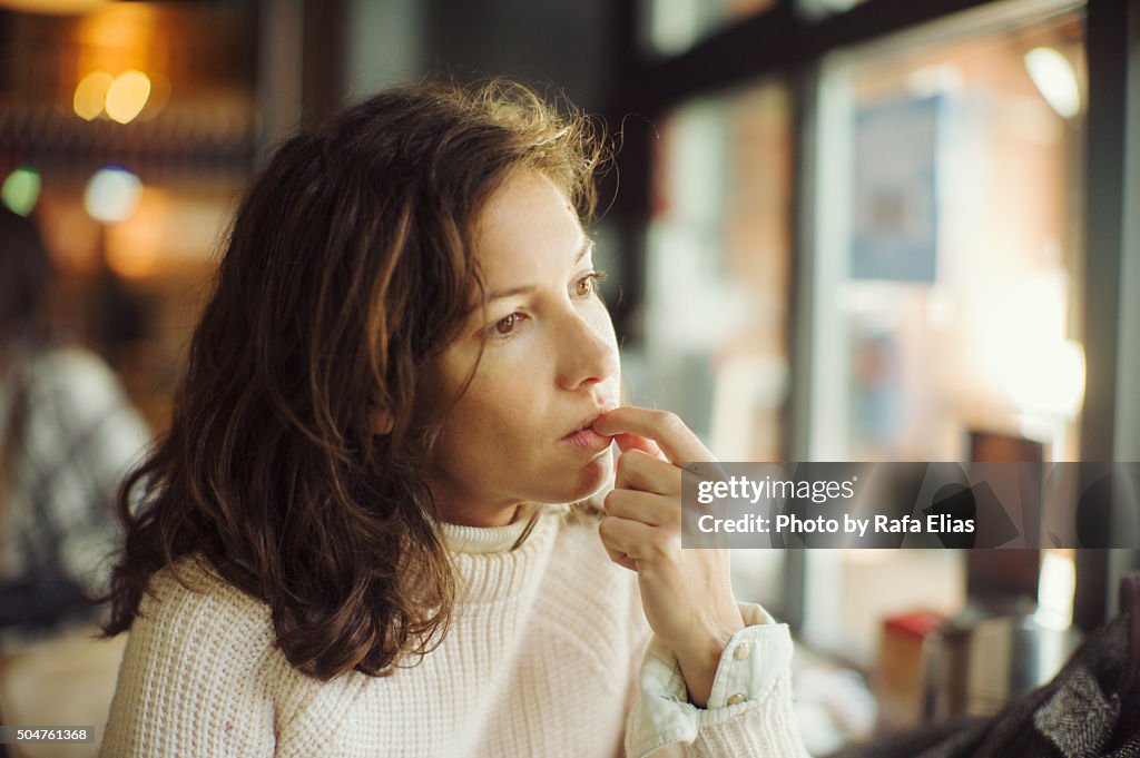 Thoughtful woman in bar