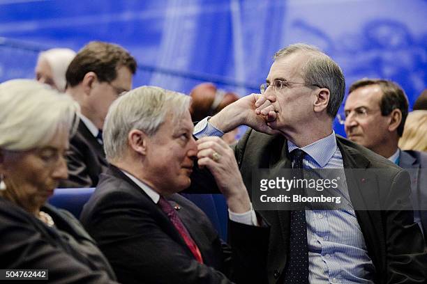 Francois Villeroy de Galhau, governor of the Bank of France, right, sits beside Christian Noyer, former governor of the Bank of France, center, and...