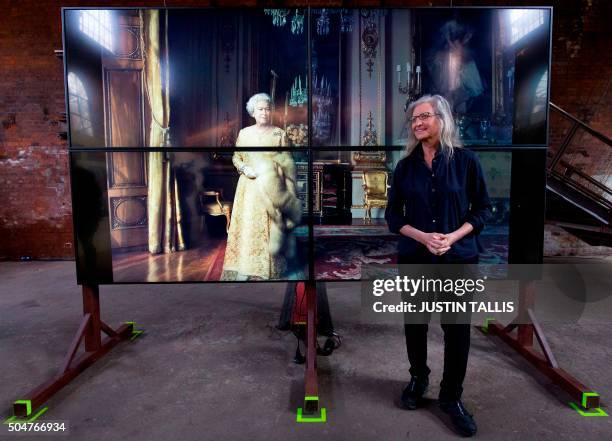 Photographer Annie Leibovitz poses in front of a photograph of Britain's Queen Elizabeth II during a photocall to promote the exhibition "Women: New...