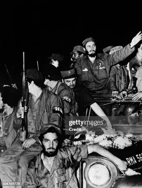 The Cuban rebel leader Fidel Castro , surrounded by the members of his leftist guerrilla movement "26th of July Movement", waves from a jeep 04...