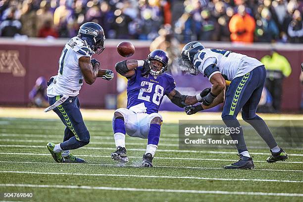 Playoffs: Seattle Seahawks Kam Chancellor in action, forcing fumble of Minnesota Vikings Adrian Peterson during 4th quarter at US Bank Stadium. Play...