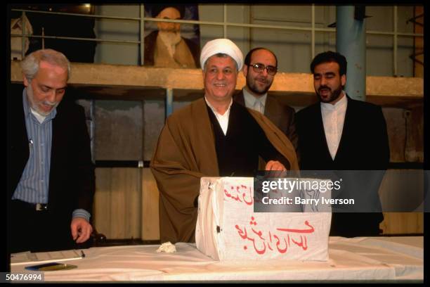 Pres. Ali Akbar Hashimi Rafsanjani casting ballot at mosque elections polling station.