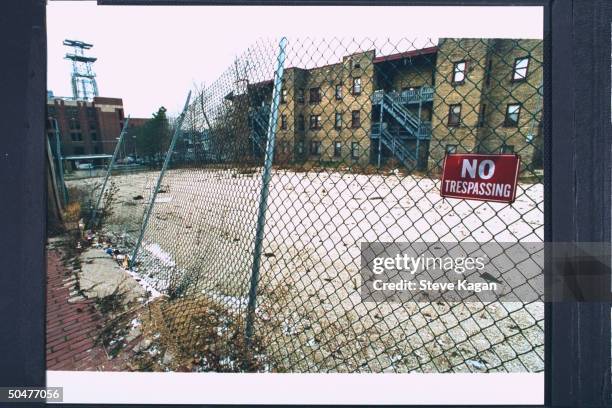 Fence-bordered vacant lot sporting a NO TRESSPASSING sign, formerly the site of the apartment bldg. Where serial killer & cannibal Jeffrey Dahmer...