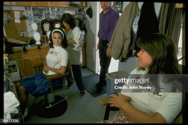 Actress Eva LaRue getting made up by as Annette Funicello as costar Andrea Nemeth looks on in dressing rm. Of TV biopic A Dream is a Wish Your Heart...