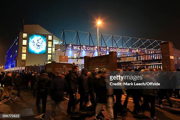 Fans make their way to the stadium under the lights ahead of the Capital One Cup Semi-Final First Leg match between Everton and Manchester City at...
