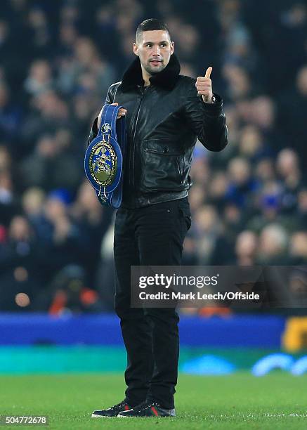 Boxer Tony Bellew makes an appearance on the pitch at half-time during the Capital One Cup Semi-Final First Leg match between Everton and Manchester...