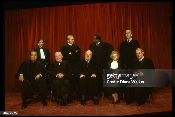 Supreme Court Justices Scalia, Ginsburg, Stevens, Souter, Chief Rehnquist, Thomas, O'Connor, Breyer & Kennedy in formal portrait.