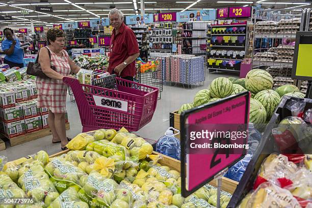 Customers browse the groceries on display inside a Game supermarket, operated by Massmart Holdings Ltd., at the Centurion Mall in Centurion, South...