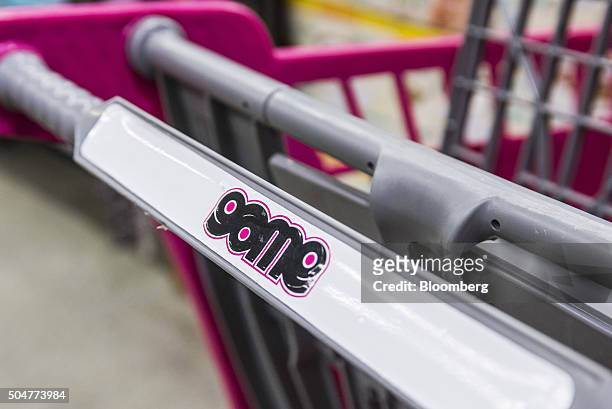 Game logo sits on the handle of a shopping cart inside a Game supermarket, operated by Massmart Holdings Ltd., at the Centurion Mall in Centurion,...