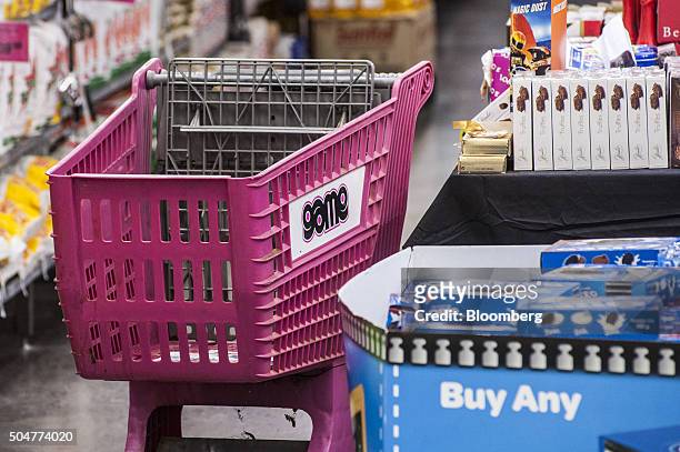 An empty shopping cart stands in an aisle inside a Game supermarket, operated by Massmart Holdings Ltd., at the Centurion Mall in Centurion, South...