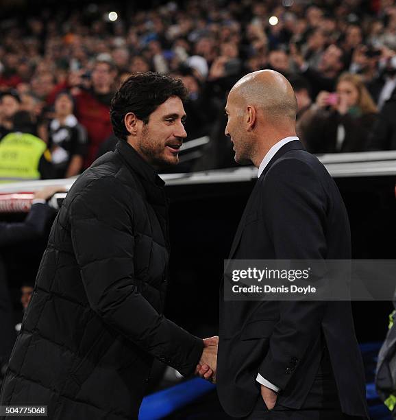 Zinedine Zidane manager of Real Madrid and Victor Sanchez del Amo manager of Deportivo La Coruna shake hands at the start of the La Liga match...