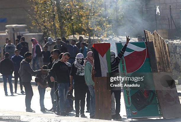 People prepare to sling stones to Israeli security forces behind a barricade after the funeral ceremony of Palestinian Surur Ahmed Ebu Surur, who has...