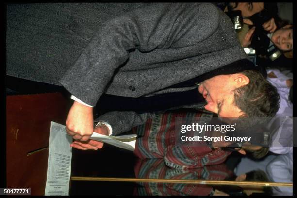 Ultra-nationalist Liberal Democrats ldr. Vladimir Zhirinovsky inserting ballot in box, voting in 1st democratic parliamentary elections.