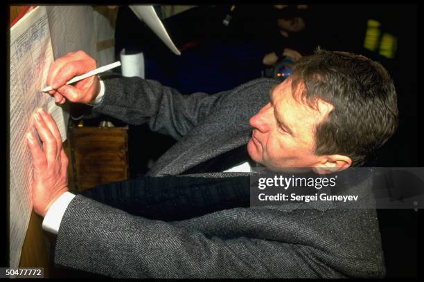 Ultra-nationalist Liberal Democrats ldr. Vladimir Zhirinovsky marking ballot, voting in 1st democratic parliamentary elections.