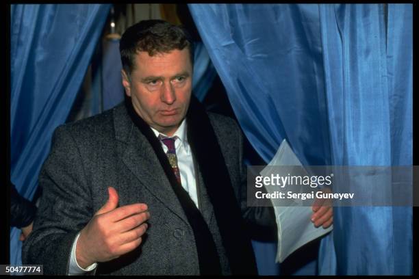 Ultra-nationalist Liberal Democrats ldr. Vladimir Zhirinovsky emerging fr. Voting booth during 1st democratic parliamentary elections.